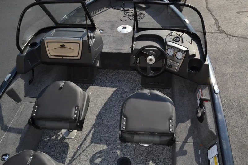 Slide: The Image of 2025 Tracker Pro Guide V-16 WT boat interior with steering console and seating. - 3