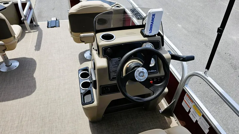 Slide: The Image of 2025 Sun Tracker Bass Buggy 18 DLX boat console with steering wheel and navigation system. - 8