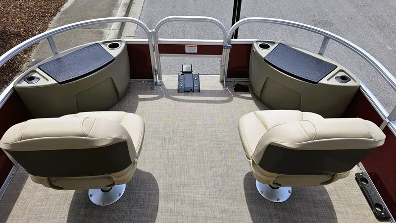 Slide: The Image of 2025 Sun Tracker Bass Buggy 18 DLX pontoon boat interior with seating and storage compartments. - 9