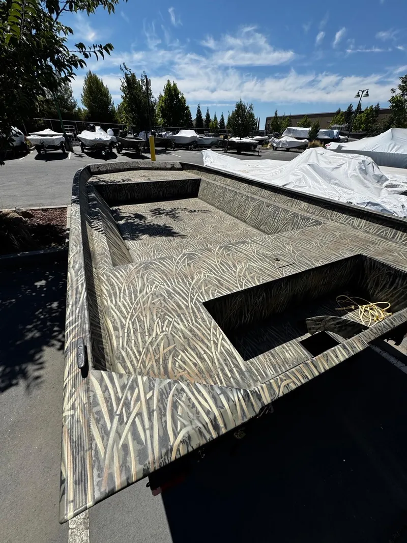 Slide: The Image of 2025 Tracker GRIZZLY 2072 Utility boat with camouflage design in outdoor setting. - 3