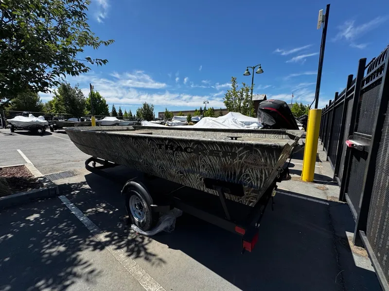 Slide: The Image of 2025 Tracker GRIZZLY 2072 Utility boat on trailer in parking lot, sunny day. - 4