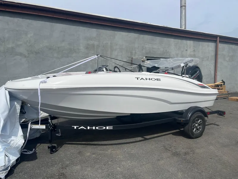 The Image of 2025 Tahoe T16 boat on trailer, parked outdoors, side view. - 0