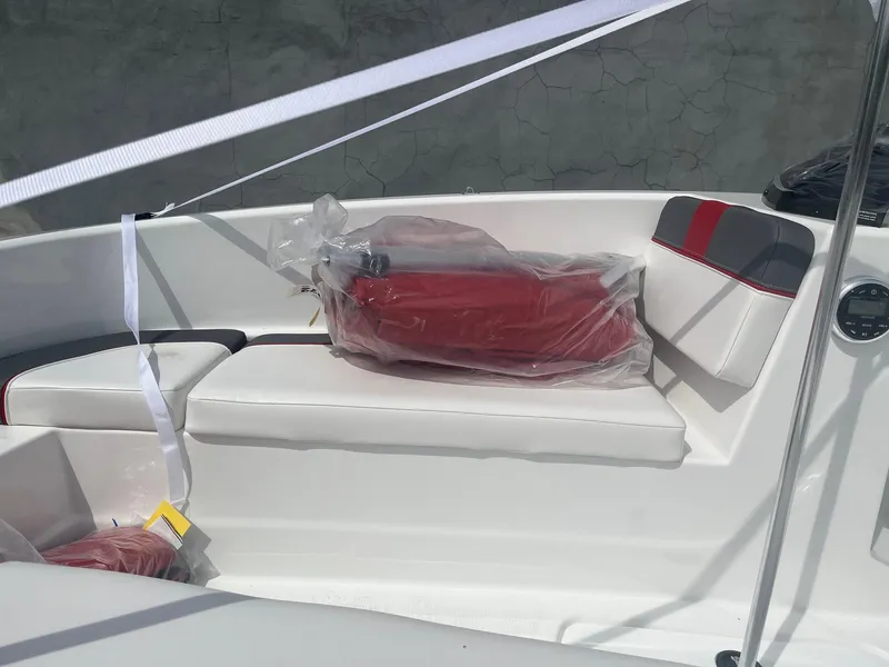 Slide: The Image of 2025 Tahoe T16 boat interior with white and red seating, wrapped cushions, and modern design. - 5