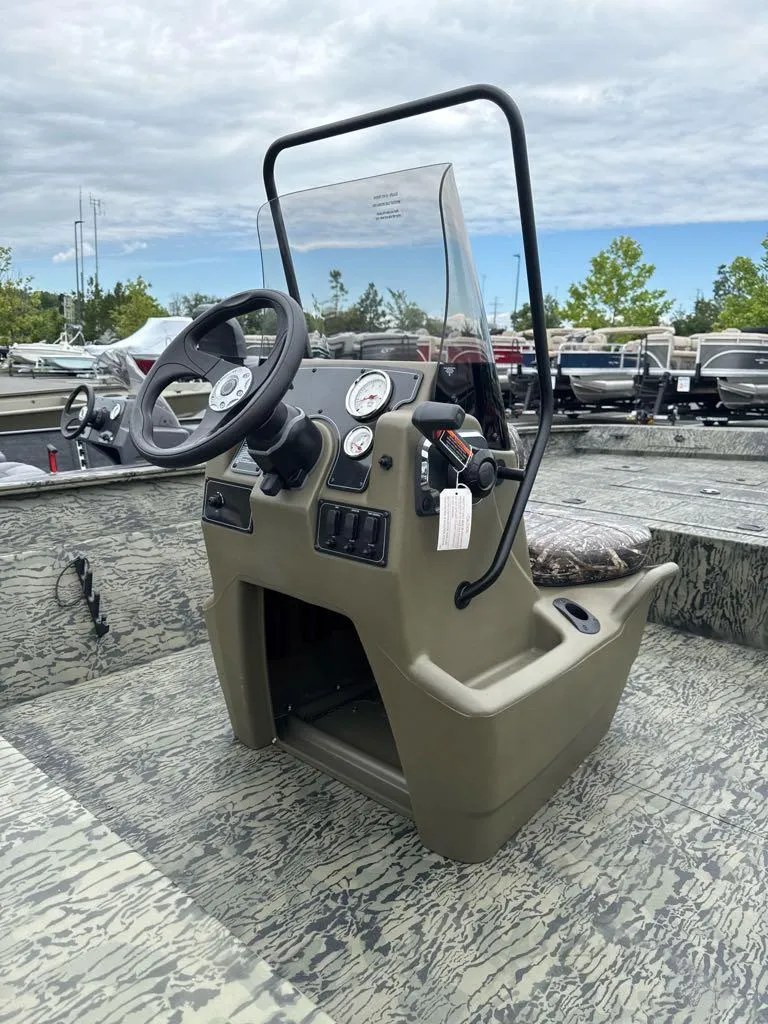 Slide: The Image of 2025 Tracker Grizzly 2072 CC boat console with steering wheel and gauges. - 3