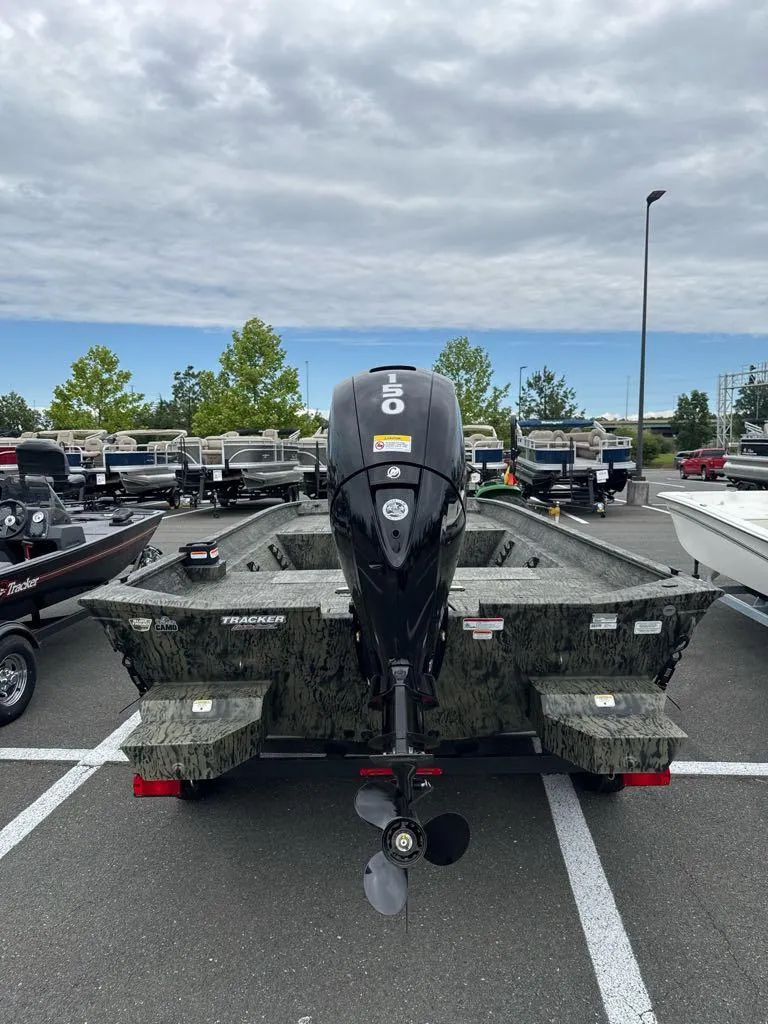 Slide: The Image of 2025 Tracker Grizzly 2072 CC boat in a parking lot, rear view. - 4