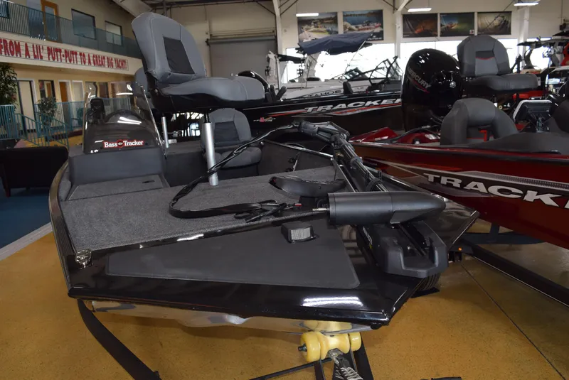 Slide: The Image of 2025 Tracker Bass Tracker Classic XL boat displayed in showroom, featuring sleek design and seating. - 4