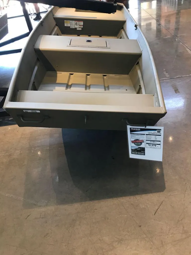 Slide: The Image of 2025 Tracker Grizzly 15 Jon boat displayed indoors on a polished floor. - 2