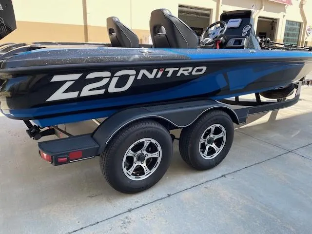 Slide: The Image of 2024 Nitro Z20 boat on trailer, featuring sleek design and dual axles. - 1