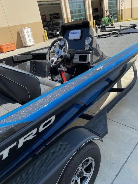 Slide: The Image of 2024 Nitro Z20 boat with sleek design and modern dashboard, parked outdoors. - 3