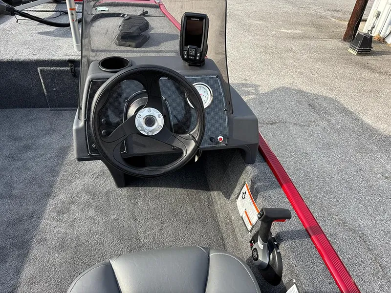 Slide: The Image of 2025 Tracker Bass Tracker Classic XL boat dashboard with steering wheel and navigation system. - 17