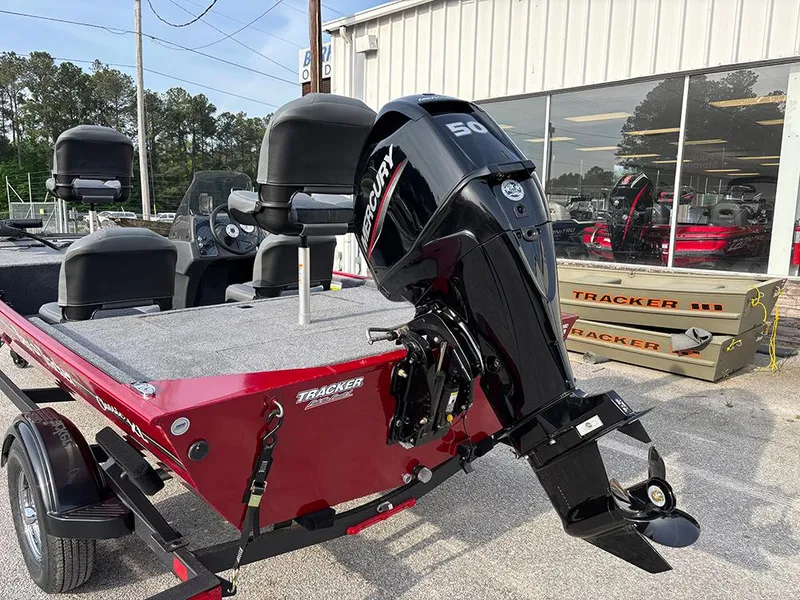 Slide: The Image of 2025 Tracker Bass Tracker Classic XL boat with Mercury engine, parked outside dealership. - 21