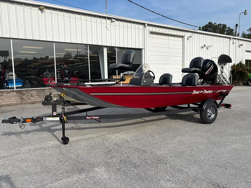 Slide: The Image of 2025 Tracker Bass Tracker Classic XL boat on trailer, parked outside a dealership. - 3