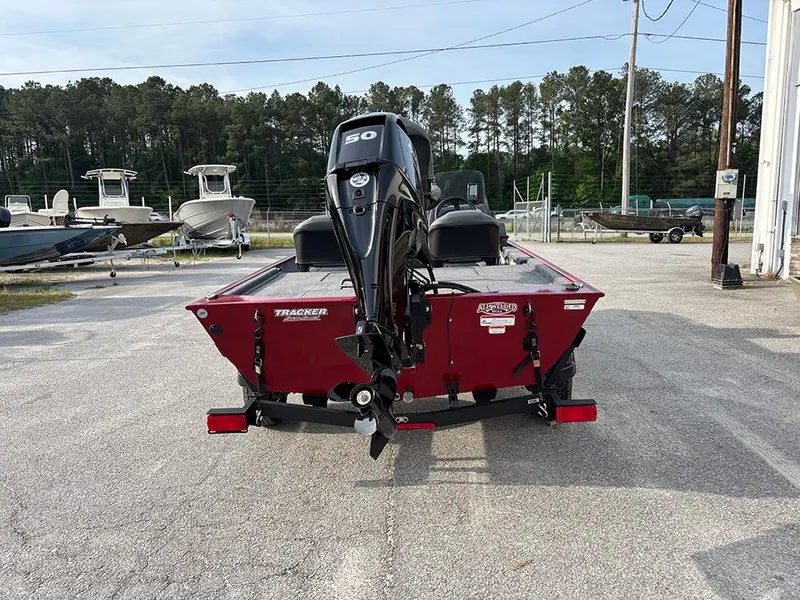 Slide: The Image of 2025 Tracker Bass Tracker Classic XL boat, red, rear view, parked outdoors. - 5
