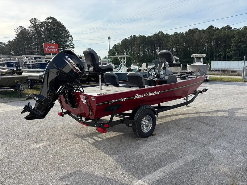 Slide: The Image of 2025 Tracker Bass Tracker Classic XL boat with Mercury engine in a parking lot. - 6