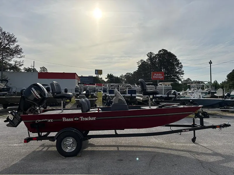 Slide: The Image of 2025 Tracker Bass Tracker Classic XL boat in a parking lot under a bright sky. - 7