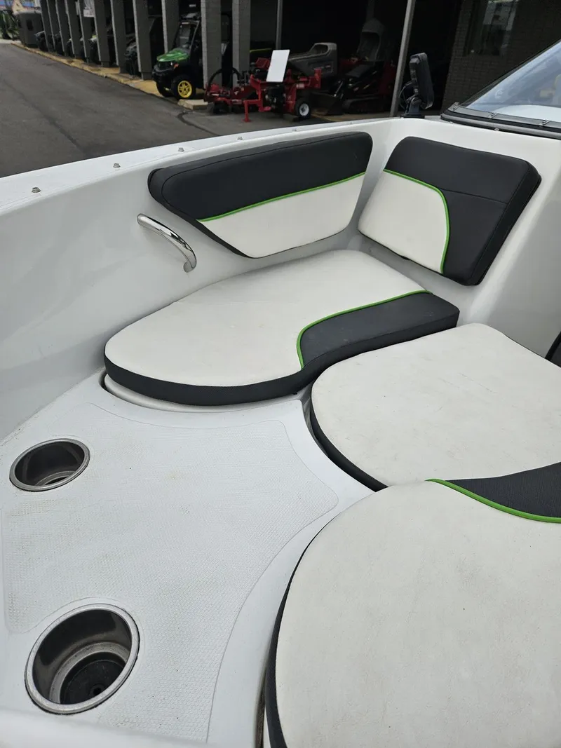 Slide: The Image of 2015 Caravelle 19EBo boat interior with cushioned seating and cup holders. - 10