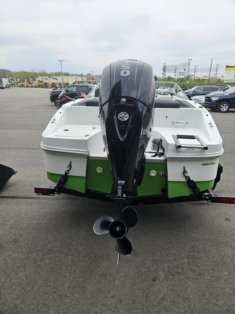 Slide: The Image of 2015 Caravelle 19EBo boat with outboard motor in a parking lot. - 3