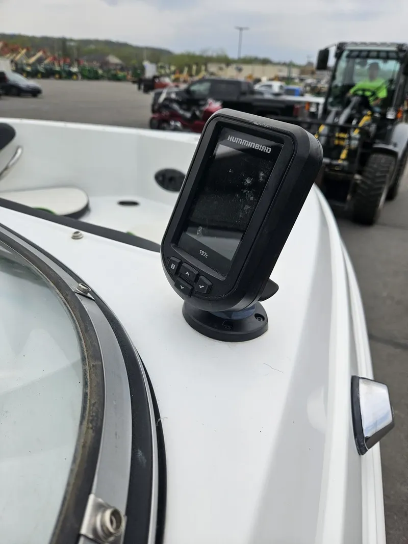 Slide: The Image of Boat dashboard with mounted electronic device, Caravelle 19EBo, 2015 model, in outdoor setting. - 6