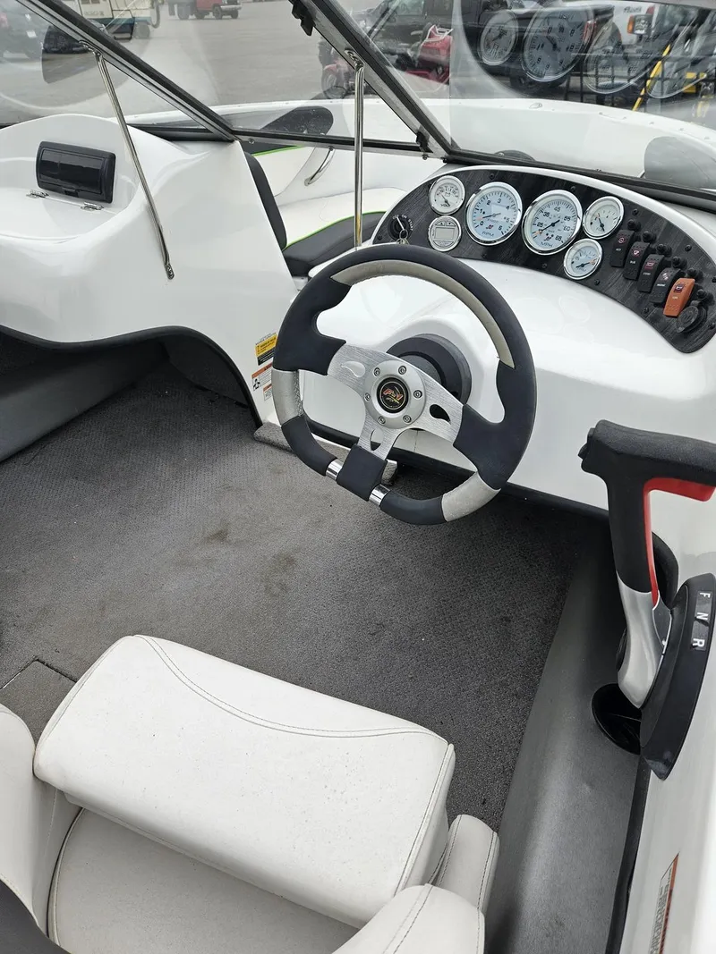Slide: The Image of Interior of a 2015 Caravelle 19EBo boat with steering wheel and dashboard. - 7