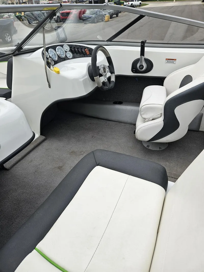Slide: The Image of Interior of a 2015 Caravelle 19EBo boat with white and black seating. - 9