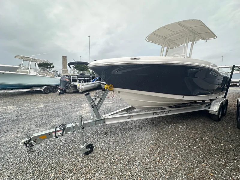 Slide: The Image of 2023 Robalo R200 Center Console boat on trailer, parked outdoors. - 1