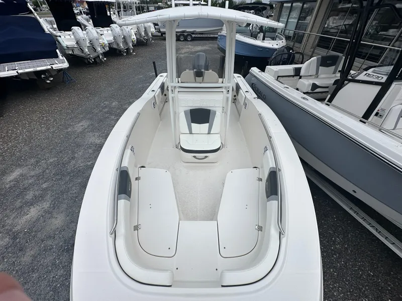 Slide: The Image of 2023 Robalo R200 Center Console boat with spacious seating, displayed in a marina. - 10