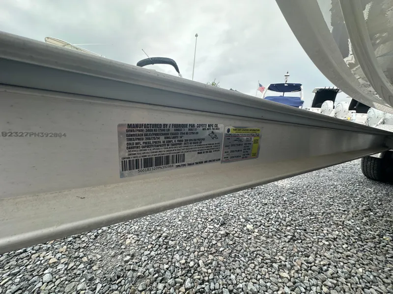 Slide: The Image of 2023 Robalo R200 Center Console trailer label on gravel surface. - 15