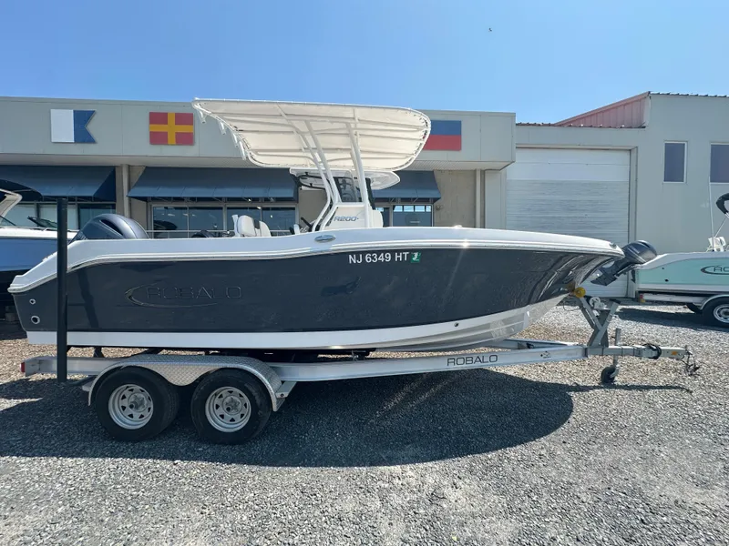 Slide: The Image of 2023 Robalo R200 Center Console boat on trailer, parked outdoors. - 16