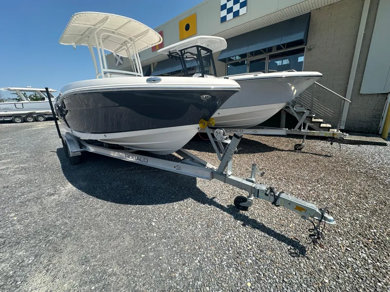 Slide: The Image of 2023 Robalo R200 Center Console boat on trailer, parked outdoors. - 17