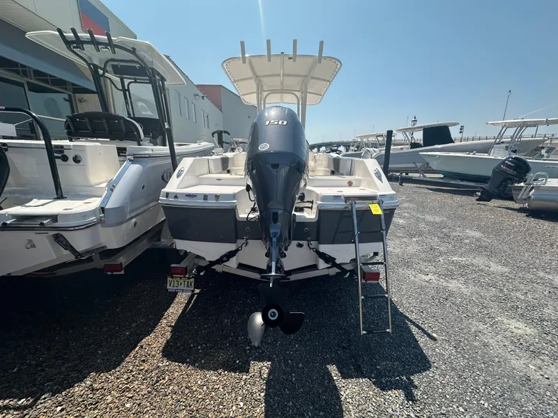 Slide: The Image of 2023 Robalo R200 Center Console boat with outboard motor, parked on gravel lot. - 19