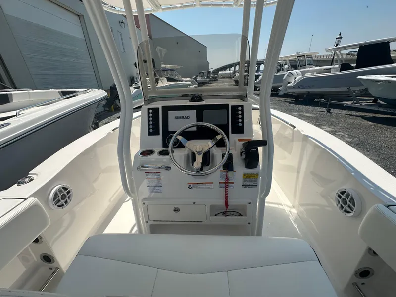 Slide: The Image of 2023 Robalo R200 Center Console boat interior with steering wheel and control panel. - 24