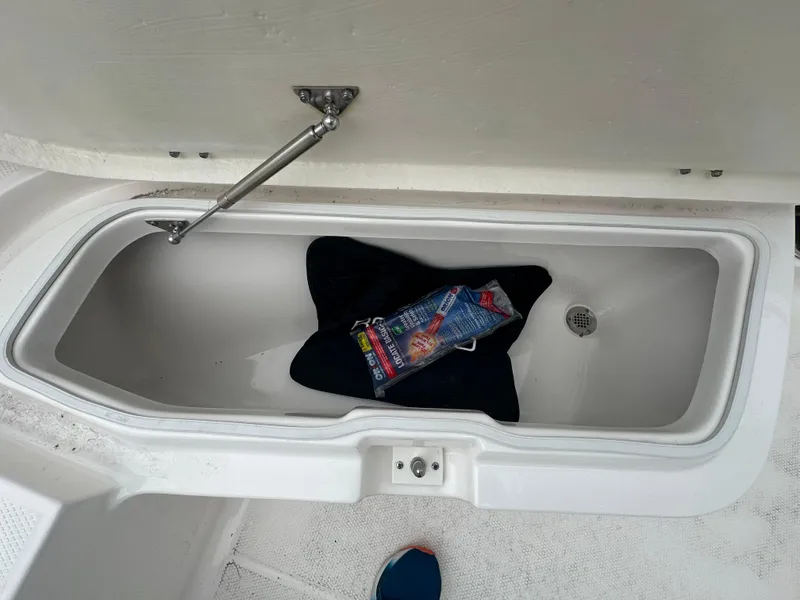 Slide: The Image of Open storage compartment on 2023 Robalo R200 Center Console boat. - 7