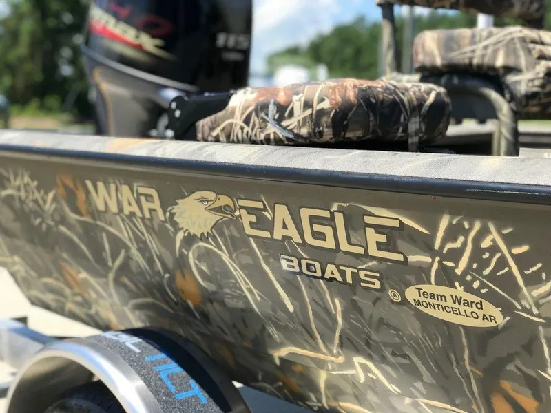 Slide: The Image of War Eagle Blackhawk 961 boat, camo design, 2025 model, featuring logo and seating. - 13