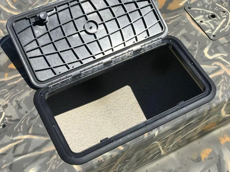 Slide: The Image of Open storage compartment on 2025 War Eagle Blackhawk 961 boat, featuring a durable lid design. - 7