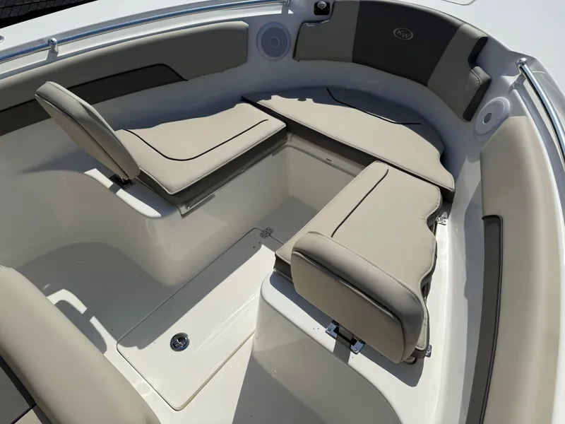 Slide: The Image of 2025 Key West 260 CC boat interior with beige cushioned seating and storage compartments. - 16