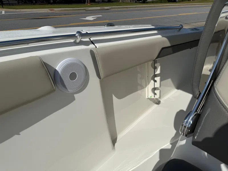 Slide: The Image of 2025 Key West 260 CC boat interior with speaker and cushioned seating. - 22