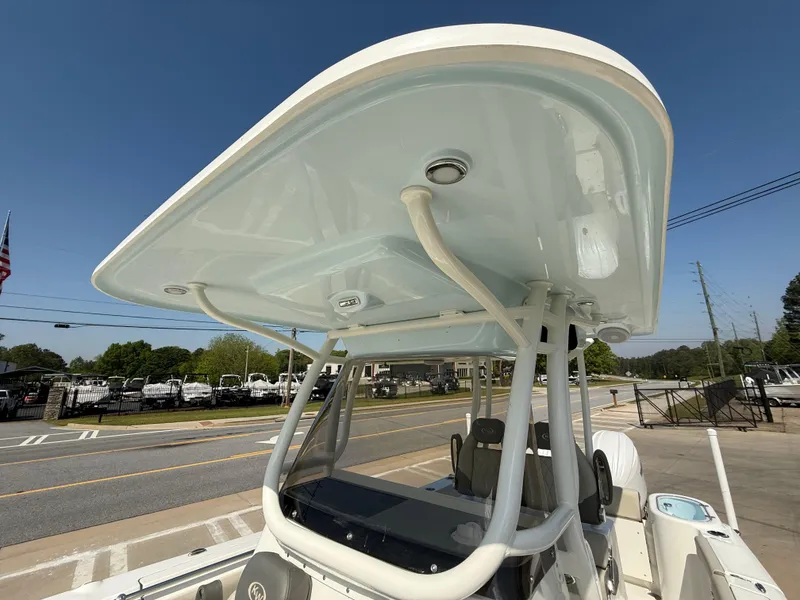 Slide: The Image of 2025 Key West 260 CC boat with sleek T-top design, parked on a sunny street. - 23