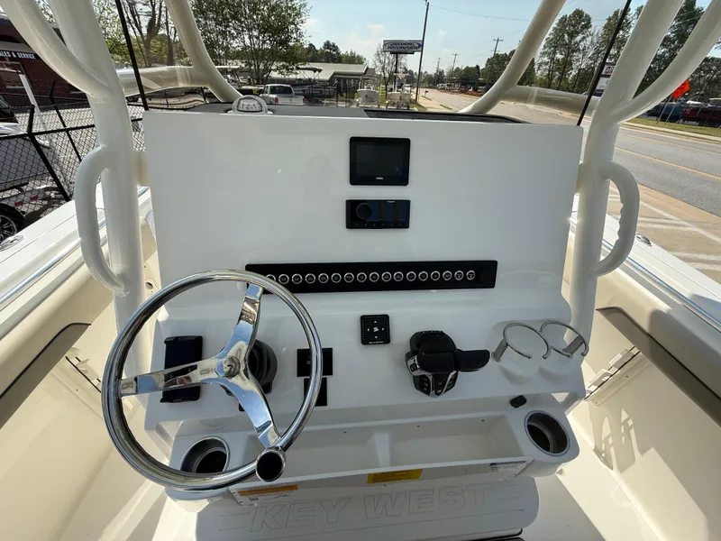 Slide: The Image of 2025 Key West 260 CC boat dashboard with steering wheel and controls. - 26