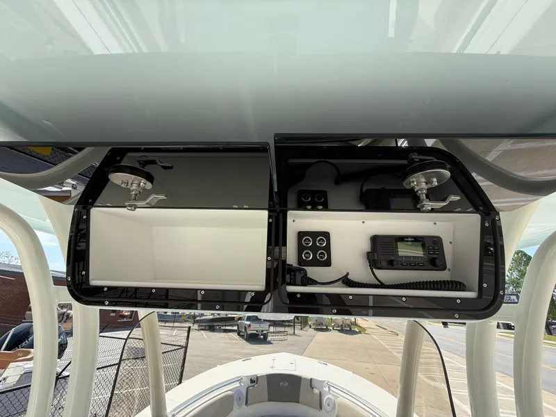 Slide: The Image of 2025 Key West 260 CC boat console with open storage compartments and electronic controls. - 29