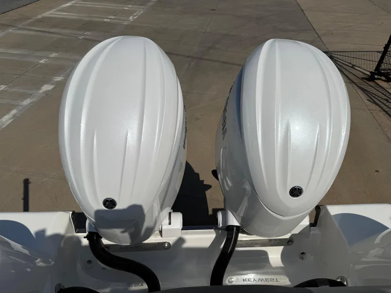 Slide: The Image of Twin outboard motors on a 2025 Key West 260 CC boat, dockside view. - 33