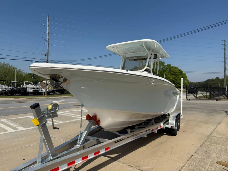 Slide: The Image of 2025 Key West 260 CC boat on trailer, parked outdoors under clear blue sky. - 4