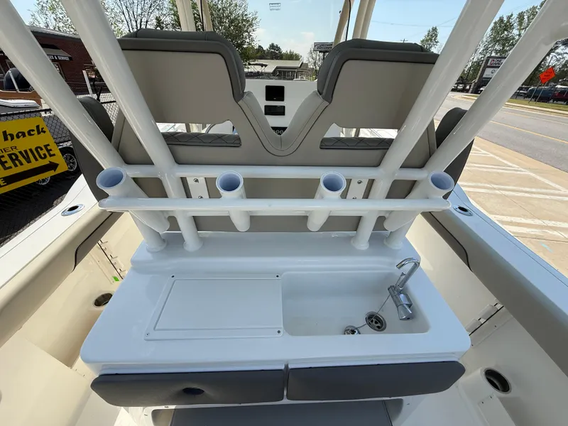 Slide: The Image of 2025 Key West 260 CC boat interior with rod holders and sink station. - 42