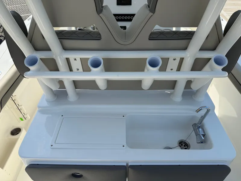 Slide: The Image of Key West 260 CC 2025 boat console with rod holders and sink. - 48