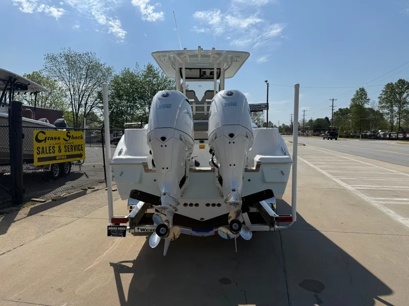 Slide: The Image of 2025 Key West 260 CC boat with dual outboard engines, parked at a sales and service center. - 5