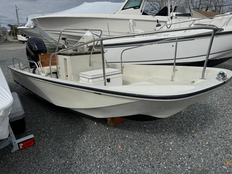 Slide: The Image of 1993 Boston Whaler Montauk 17 CC boat on gravel lot, side view. - 1