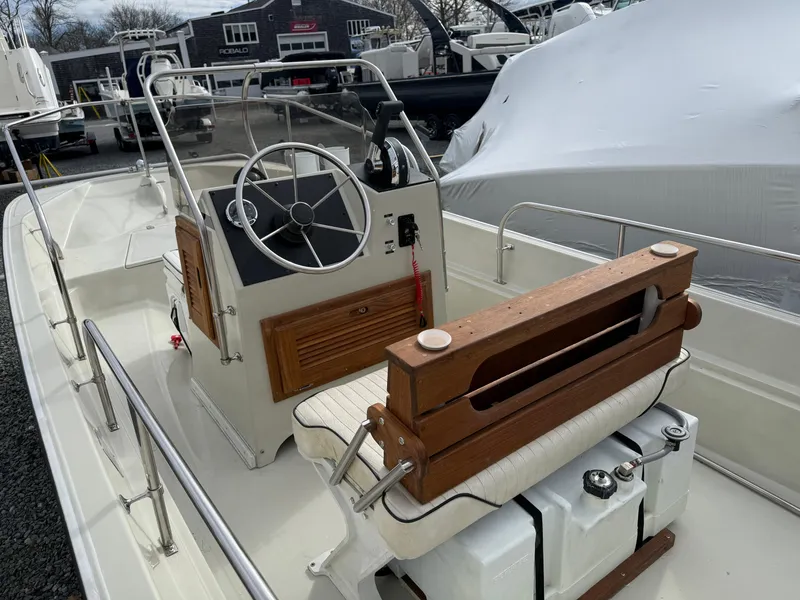 Slide: The Image of 1993 Boston Whaler Montauk 17 CC boat interior with steering wheel and seating. - 6