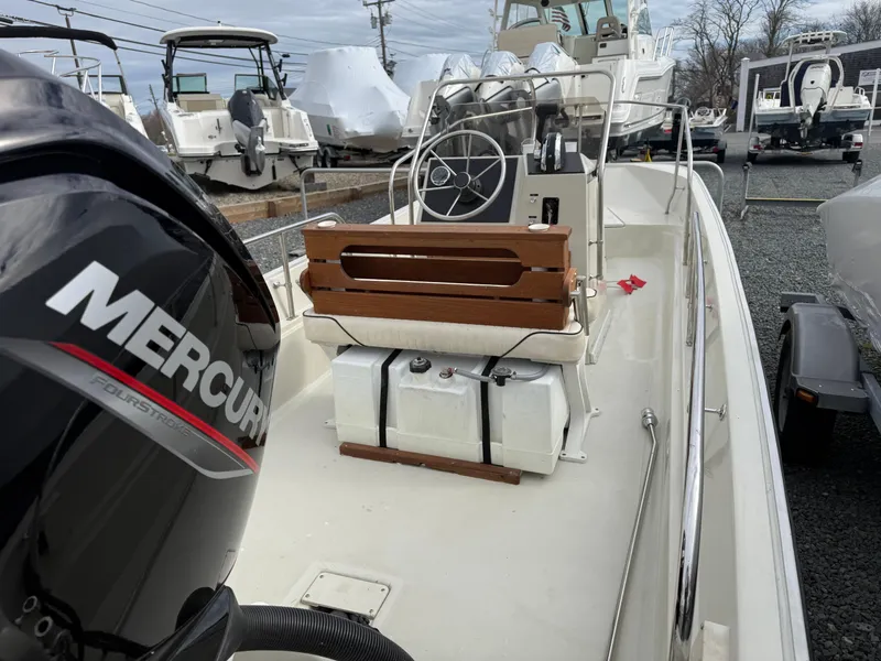 Slide: The Image of 1993 Boston Whaler Montauk 17 CC boat with Mercury engine, docked in a marina. - 7