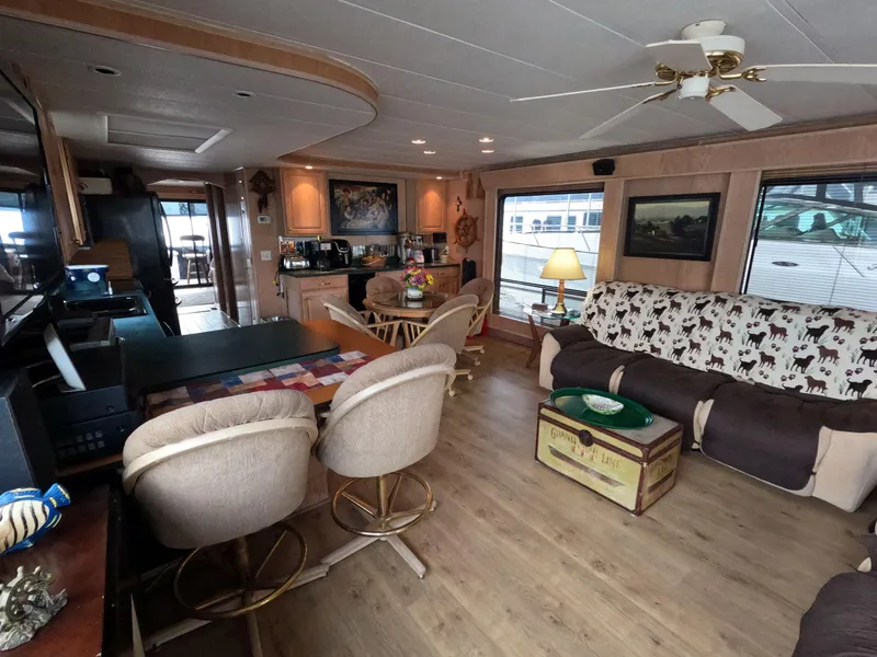 Slide: The Image of Interior of 1998 Jamestowner 1667WB Americana Custom houseboat, featuring cozy seating and nautical decor. - 24
