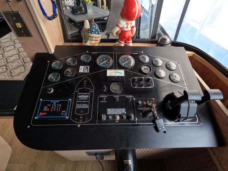 Slide: The Image of Control panel of a 1998 Jamestowner 1667WB Americana Custom houseboat with gauges and decorations. - 28