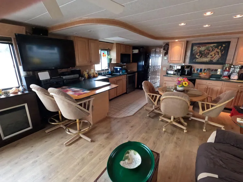 Slide: The Image of Interior of 1998 Jamestowner 1667WB Americana Custom houseboat with modern kitchen and dining area. - 33